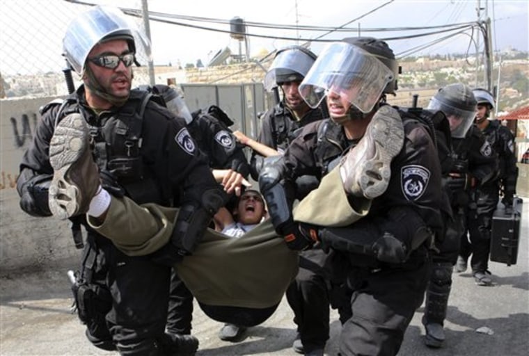 Israeli border police arrest a Palestinian youth for throwing stones at their checkpoint in Ras Al-Amud neighborhood of East Jerusalem on Friday.